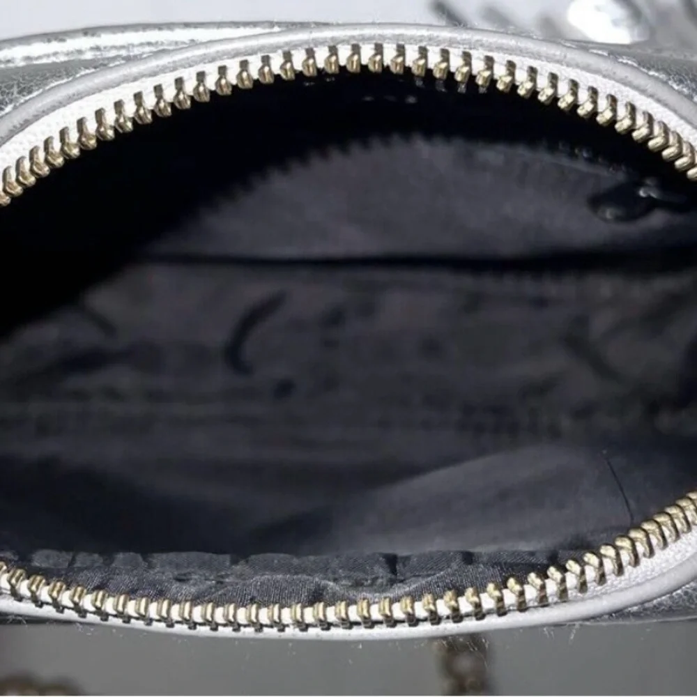 Victoria’s Secret silver snake skin purse with gold chain strap.